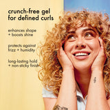 Woman with curly hair holding her face, with text about a crunch-free gel for defined curls.