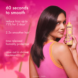 Woman holding a bottle of hair product with text on a pink background