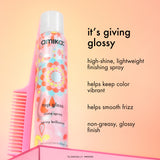 Amika hair spray with comb on a peach background