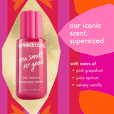 Amika: Aura 'You Smell So Good' hair and body mist in a supersized pink bottle, presented on a vibrant pink, orange, and gold graphic background with text detailing the scent notes.