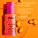 Amika Superfruit Star hair styling oil bottle with product details on an orange background