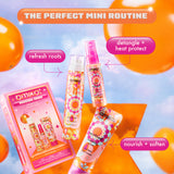 “A promotional image for Amika's 'Mission Minis' set showcasing a 'perfect mini routine' with three products against a colorful sky with floating orange balloons. The top banner reads 'The Perfect Mini Routine' in an orange and white gradient. The products are displayed outside the box, with captions highlighting their benefits: 'refresh roots' next to the Perk Up Dry Shampoo, 'detangle + heat protect' next to The Wizard Detangling Primer, and 'nourish + soften' next to the Soulfood Nourishing Mask. The pac