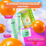 A promotional image for Amika's 'Play Your Strength' strand-strengthening routine set. The image features the products included in the set, displayed outside of the box against a colorful sky with floating orange balloons. The top banner reads 'A Strand-Strengthening Routine' in an orange and white gradient. The products are labeled with their specific functions: 'cleanse' next to The Kure Bond Repair Shampoo, 'condition' next to The Kure Bond Repair Conditioner, and 'intense weekly treatment' next to The K