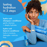 A woman with curly hair leans against a blue surface, holding two blue haircare bottles, with text on a bright blue graphic background reading 'lasting hydration in 3 steps' and product names for shampoo, conditioner, and leave-in conditioner.