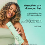 Woman holding a bottle of shampoo with text about hair care benefits on a teal background