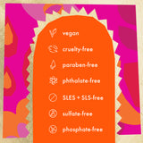 A colorful graphic with an orange arch-shaped panel listing product attributes such as vegan, cruelty-free, paraben-free, phthalate-free, SLES + SLS-free, sulfate-free, and phosphate-free, set against a bright pink and orange patterned background.