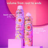 Two colorful hair spray bottles with text on a pink and purple gradient background. "volume from root to ends. boost volume at the root with rising star. add texture from mid-lengths to ends with un.done."