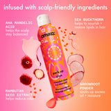 Amika shampoo bottle with scalp care ingredients on a pink and orange gradient background