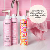 amika reset shampoo and conditioner and perk up dry shampoo sit in front of a pink sink. Text reads: "perfect for dry shampoo lovers to breakdown product buildup"