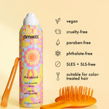 Amika anti-humidity spray bottle with vegan, cruelty-free, paraben-free, phthalate-free, SLES + SLS-free, and color-treated hair compatible text on a yellow background.