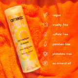 Amika velveteen dream smoothing balm on an orange background with product features listed.