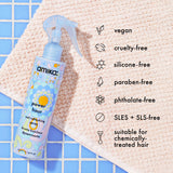Amika power hour curl refreshing spray bottle with product features listed on a towel background