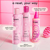 Amika hair care products on a pink tiled background with text describing product benefits.
