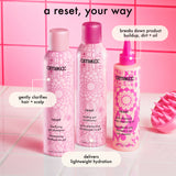 amika reset shampoo and conditioner and reset scalp cleansing oil sit on a pink counter. Text reads: "a reset, your way. shampoo gently clarifies hair + scalp. conditioner delivers lightweight hydration, reset oil breaks down product buildup, dirt + oil"
