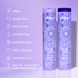 Two Amika hair product bottles with purple and blue designs on a light purple background, featuring brand name and product details.
