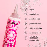 Amika pink charcoal soap cleansing oil bottle on a pink background with product features listed.