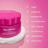 big embrace body butter jar sits on a swirl of white cream against a pink gradient background. text and icons list attributes including vegan, cruelty-free, paraben-free, no artificial color, SLES and SLS-free, no mineral oil, phosphate-free, and silicone-free.