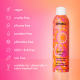 Amika dry shampoo bottle with product features on a pink and orange gradient background