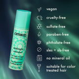 Amika hair treatment product with green label on a dark green background, featuring product details.