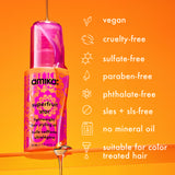 a bottle of amika superfruit star sits on a glass shelf with oil pouring down the bottle. text lists benefits of superfruit star: vegan, cruelty-free, sulfate-free, paraben-free, phthalate-free, sles +sls-free, no mineral oil, suitable for color-treated hair