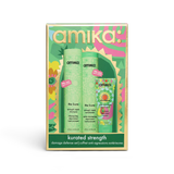 Amika 'The Kure' Damage Defense Set in a decorative green, pink, and gold box, containing a shampoo bottle and a conditioner bottle.