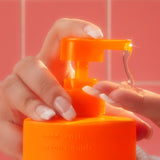 image of a model dispensing amika sea buckthorn-infused hand wash into their hands