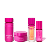 Set of Amika body care products with pink packaging on a cream background
