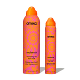 Two amika Soulstruck Nourishing Dry Hair Mask aerosols in matching orange and pink patterned cans: a larger full-size version on the left and a smaller travel-size version on the right.