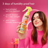Woman holding a bottle of amika hair product with text about humidity-proof hair on a pink background