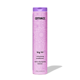 Pink bottle of amika volumizing conditioner on a white background