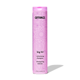 Pink shampoo bottle with 'amika' branding on a white background