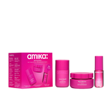 amika glowing places set; mini bottles of shower thoughts body wash, big embrace body butter, and amika:aura hair + body mist sit next to the display box
